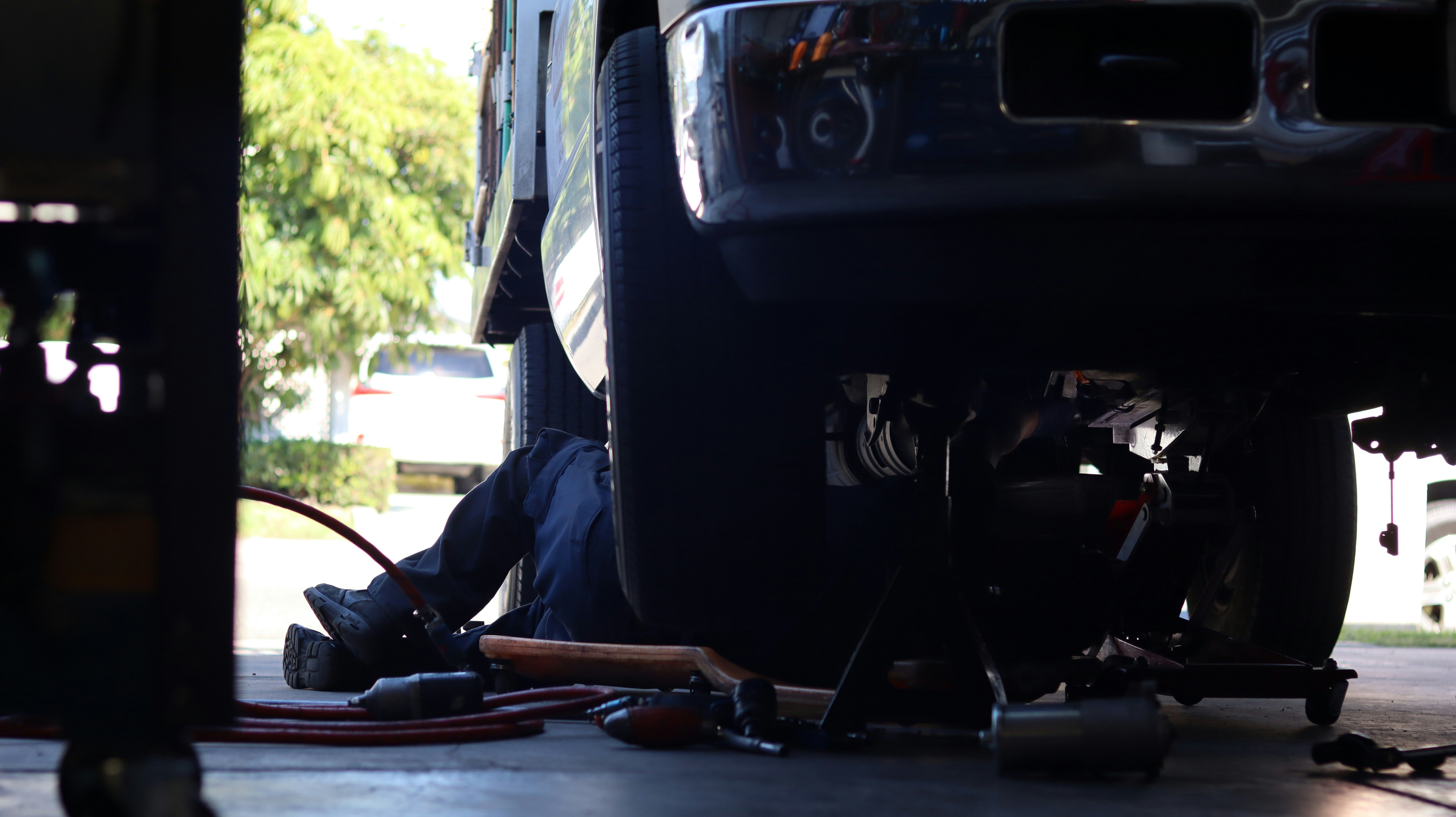 Technician working under vehicle
